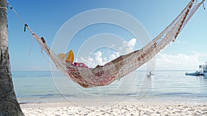 Girl relaxing in a hammock on tropical island beach. Summer vacation in Punta Cana, Dominican Republic