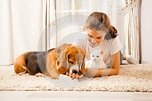 The girl is relaxing with her pets