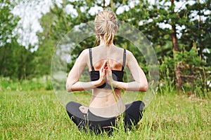 Girl relaxing in lotos yoga pose.