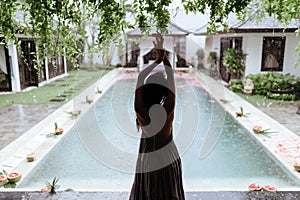 Girl relaxing in the pool on luxury villa in Bali.