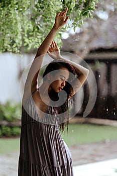 Girl relaxing in the pool on luxury villa in Bali.