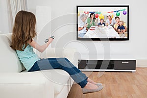 Girl With Remote Control In Front Of Television