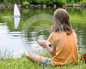 Girl with remote controlled boat