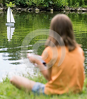 Girl with remote controlled boat