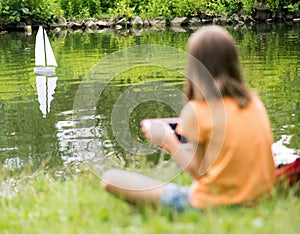 Girl with remote controlled boat