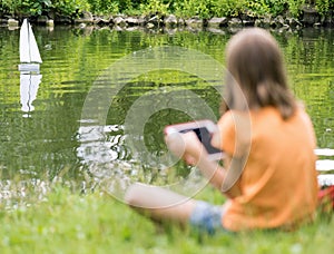 Girl with remote controlled boat