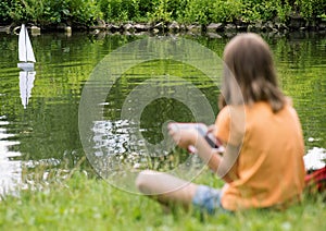 Girl with remote controlled boat