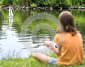 Girl with remote controlled boat