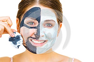 Girl remove black white mud mask from face