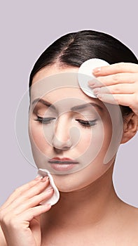 Girl remove mascara. Cotton pad. Skin care evening routine photo