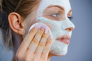 Girl removes dry white mud mask