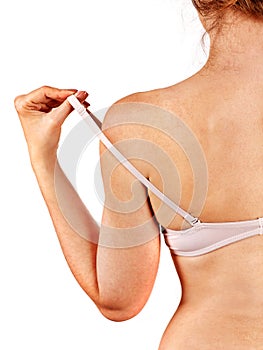 Girl removes underwear to examine their breasts. Breast self exam concept.
