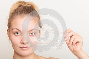 Girl removing facial peel off mask