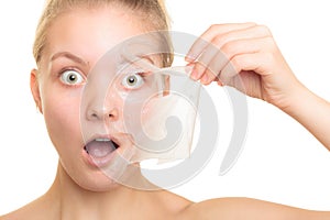 Girl removing facial peel off mask