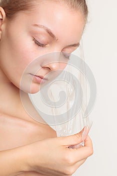 Girl removing facial peel off mask