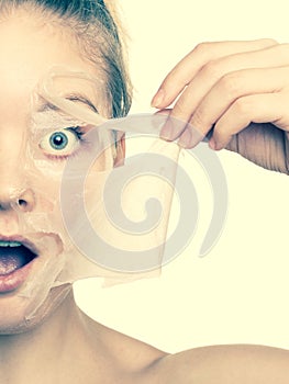 Girl removing facial peel off mask