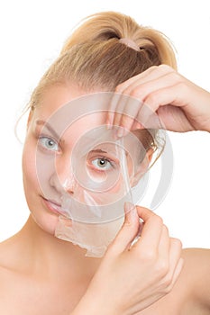 Girl removing facial peel off mask