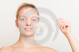 Girl removing facial peel off mask