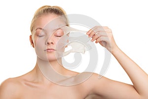 Girl removing facial peel off mask