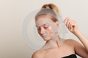 Girl removing facial peel off mask