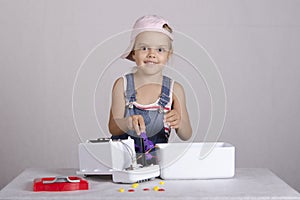 Girl repairs toy microwave