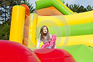 Girl Resting on Inflate Castle