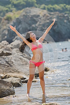 Girl resting on rocky seashore