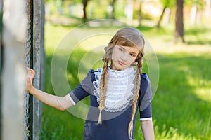 The girl is resting in the schoolyard