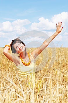 Girl resting on wheat sunny field