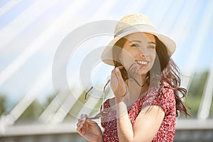 Girl rests on the river in the city. Background bridge