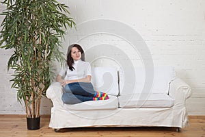 Girl rests on a soft divan