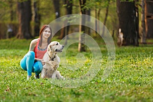 Girl with retriever in forest