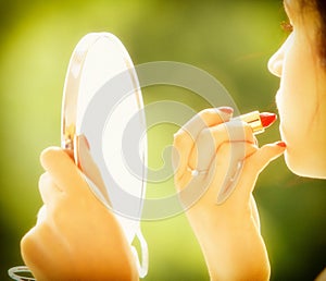 Girl retro style applying make up looking at mirror indoor