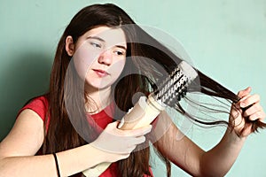 Girl revolving brush to straighten hair