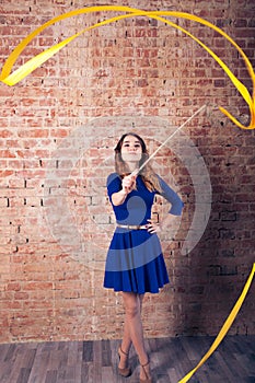 Girl with a ribbon. Brick wall