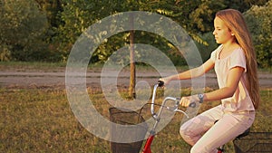 Girl ride bicycle on park alley