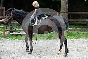 Girl ride on horse on summer day