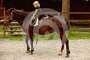 Girl ride on horse on summer day