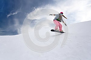 Girl rider jump on snowboard