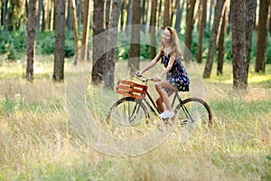 Girl rides a bicycle with a basket