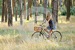 Girl rides a bicycle with a basket