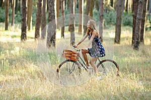 Girl rides a bicycle with a basket