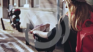 Girl rides bicycle with a cute purple flowers jar. POV slow motion. Lifestyle blogger lady on a happy city bike trip.