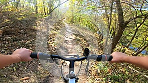 Girl rides bicycle through forest. A man on a bicycle rides in forest