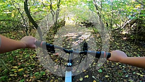 Girl rides bicycle through forest. A man on a bicycle rides in forest