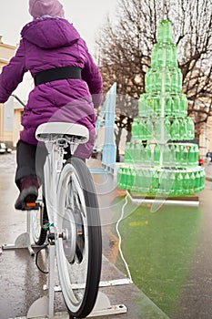 Girl rides bicycle and lights lit on Christmas photo