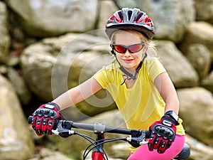 Girl rides bicycle into mountains park.