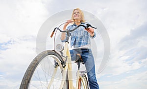 Girl rides bicycle sky background. How cycling changes your life and make you happy. Reasons to ride bicycle. Mental