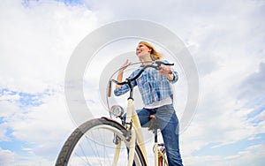 Girl rides bike sky background. Emotional woman enjoy biking holidays. Lady cyclist with cruiser bike. Girl spend