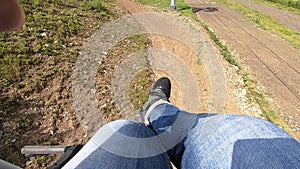 Girl rides or climbs on lift or cable car up mountain.